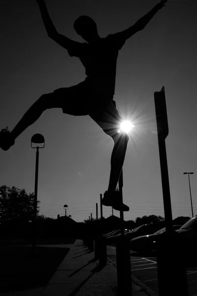 Silhouette of a skateboarder in the air.