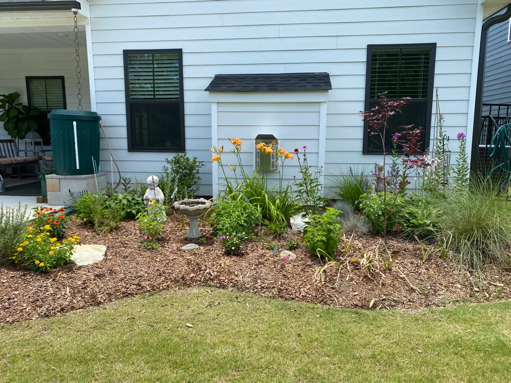 Perennial Border Bed with Orange Daylilies in the background