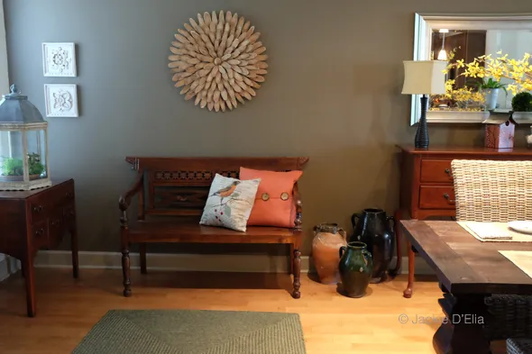 Wood bench with orange pillows