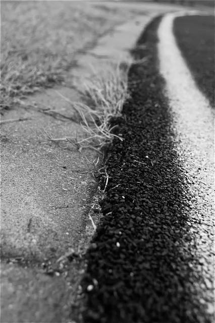 A black and white photo of a road.