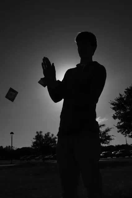 A man is throwing a kite in the air.