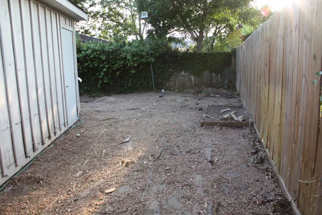 A small backyard with a wooden fence.