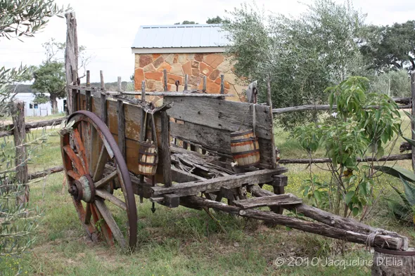An old wooden wagon sitting in a field.