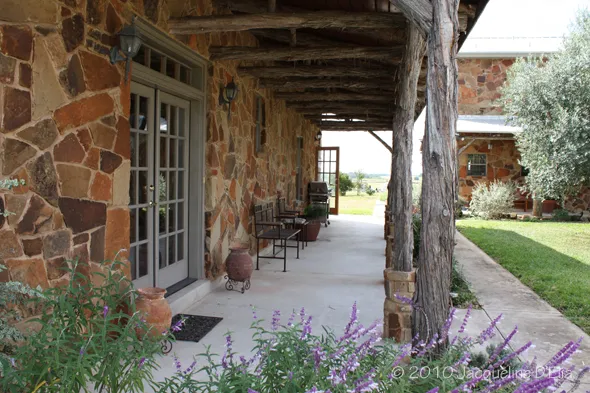 A stone building with a wooden porch.