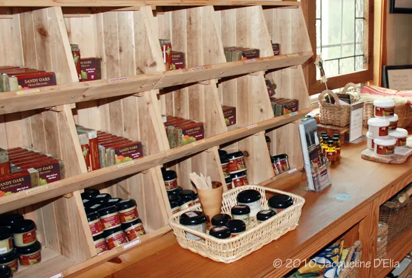 A wooden shelf with jars on it.