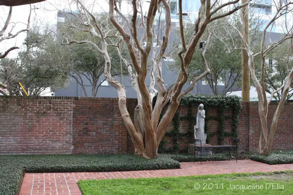 A brick wall with a statue in the middle of it.