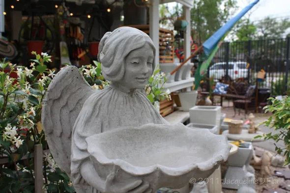 A statue of an angel holding a bowl.