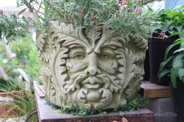 A planter with a green man on it.