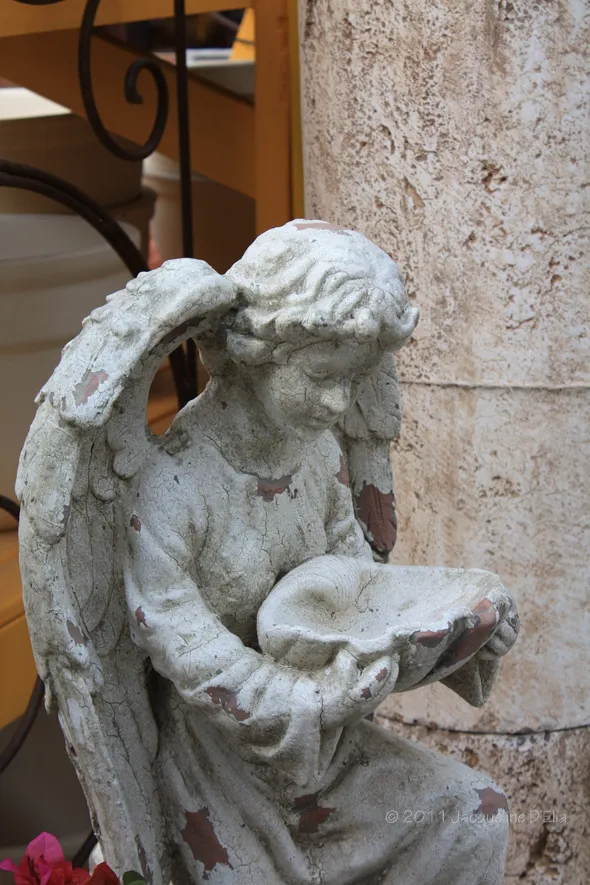 A statue of an angel holding a book.