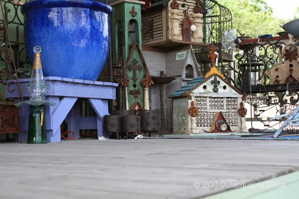 A blue pot sitting on a wooden deck.