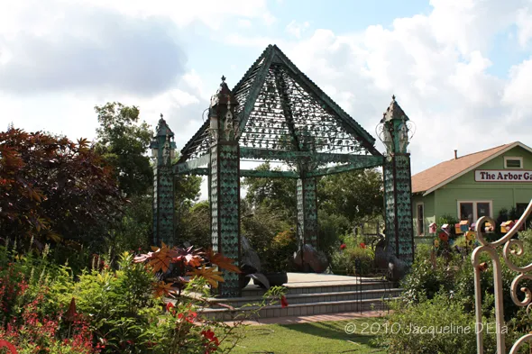 A gazebo in the middle of a garden.
