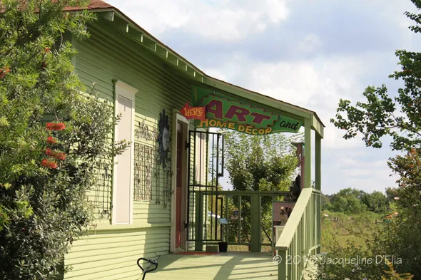 A green building with a sign on it.
