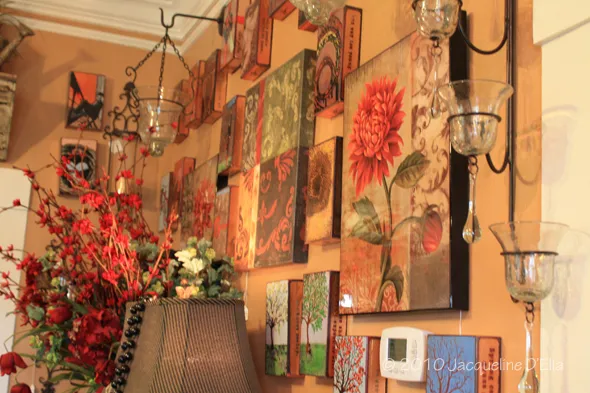 A living room with a lot of art on the wall.
