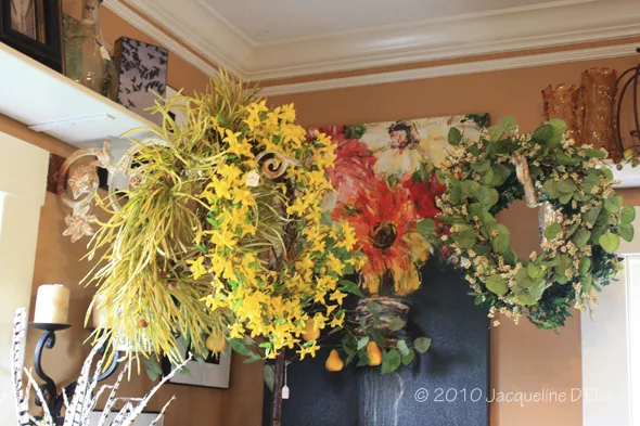 A room with a bunch of wreaths hanging on the wall.