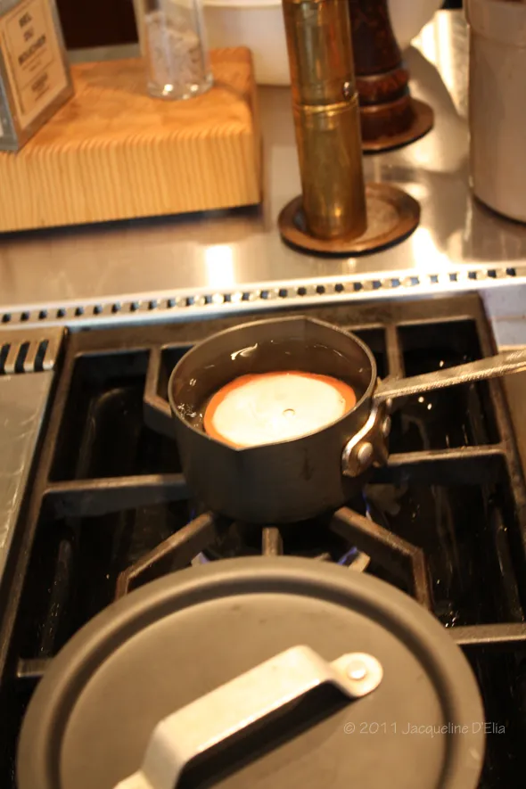 A pot on a stove used for canning tomatoes.