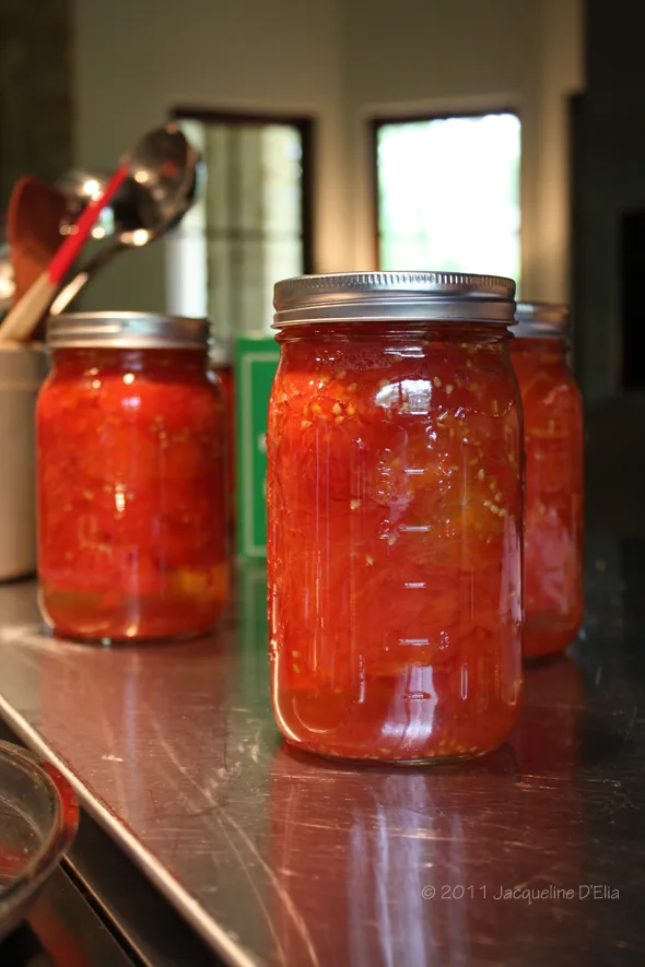 Three jars of tomato sauce sitting on a counter.