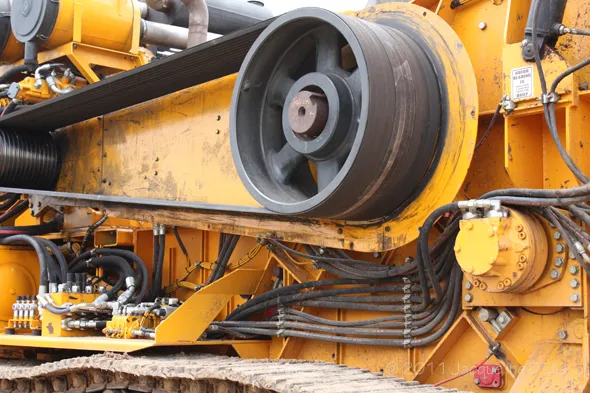 A yellow bulldozer with a lot of wires on it.