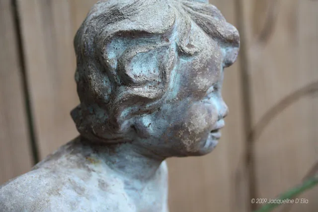 A statue of a boy with curly hair.