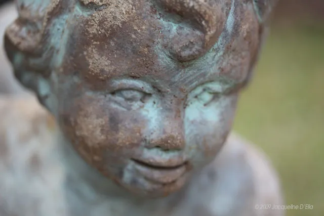 A close up of a statue of a child.