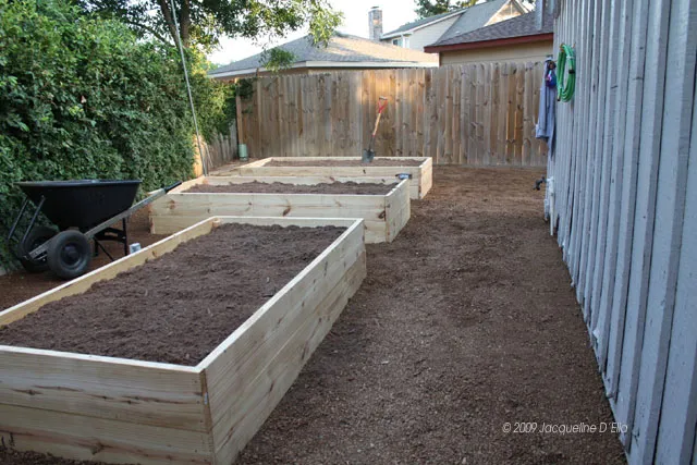 Two raised garden beds in a backyard.