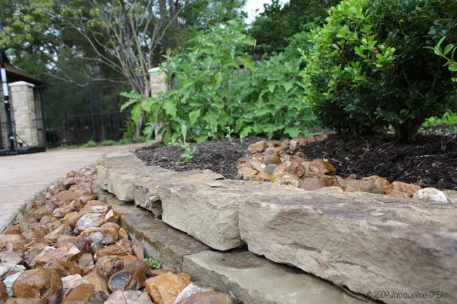 A rock retaining wall in a kitchen garden.