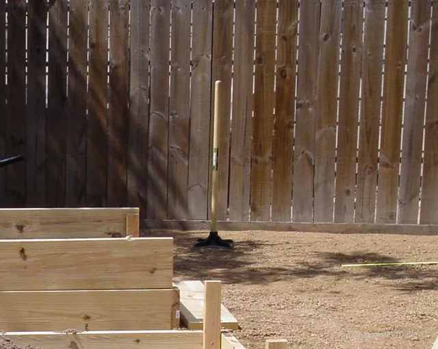 A wooden fence in a backyard.