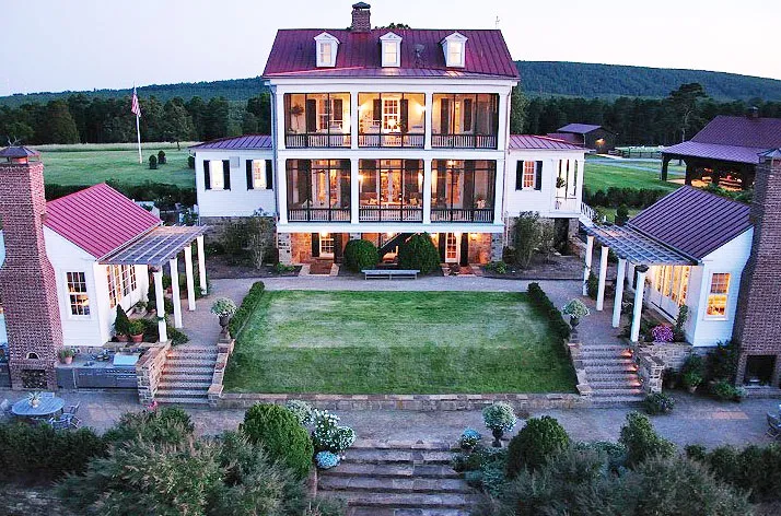 An aerial view of a large white house.
