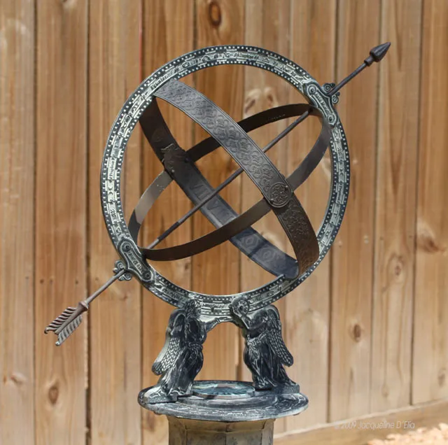 A statue of a sundial on top of a wooden base.